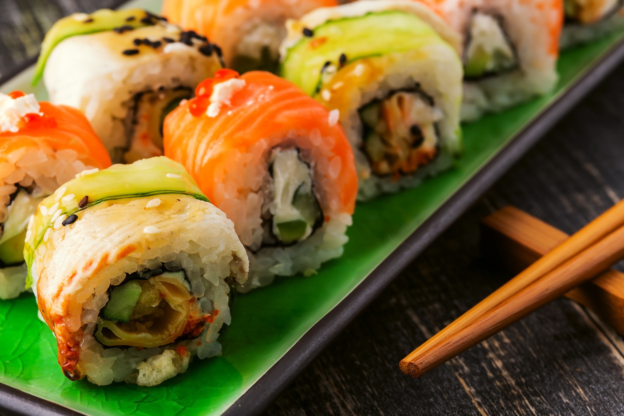 Sushi set: sushi roll with salmon and sushi roll with smoked eel, selective focus.
